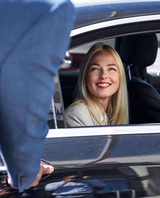 woman likes customer service in a private taxi blonde caucasian woman likes customer service in a private taxi, she looks at black male and smile, sits inside of car